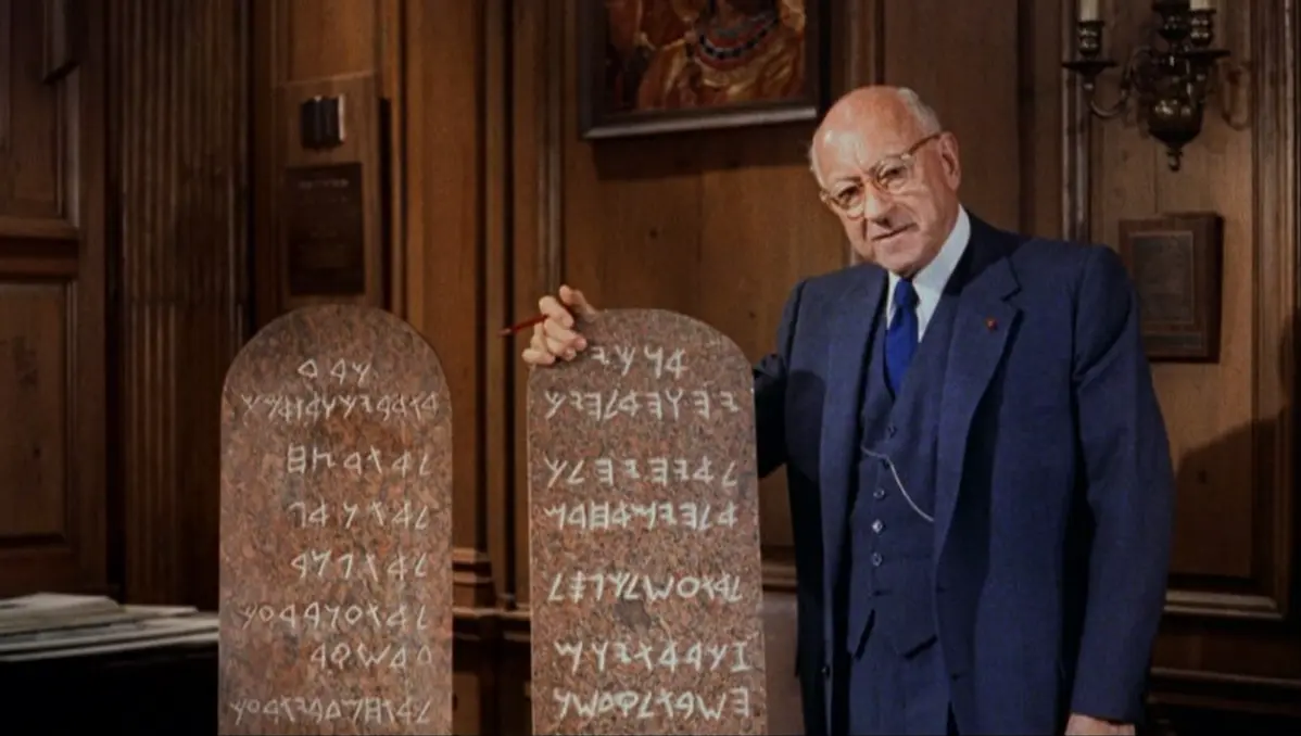 Director Cecil B. DeMille poses with a replica of the 10 Commandments tablets used in his famous movie. (Public Domain)